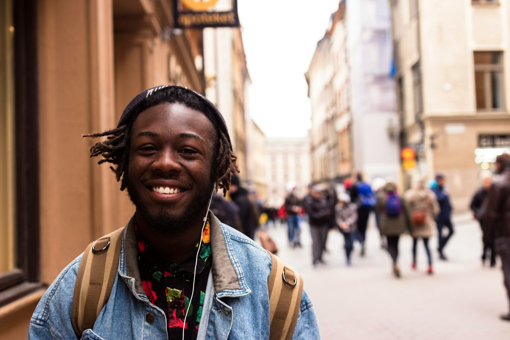 grinning young Black man wearing headphones